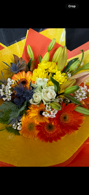 Bouquet of flowers with a yellow wrap on a black background