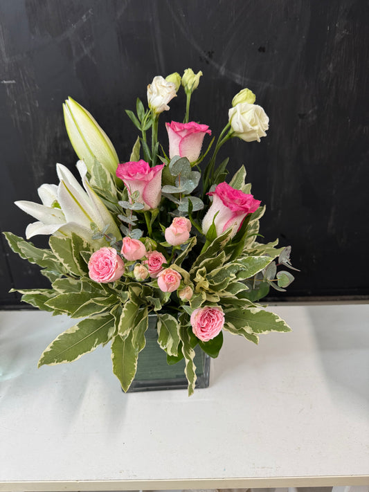 Bouquet of flowers with pink and white flowers on a black surface